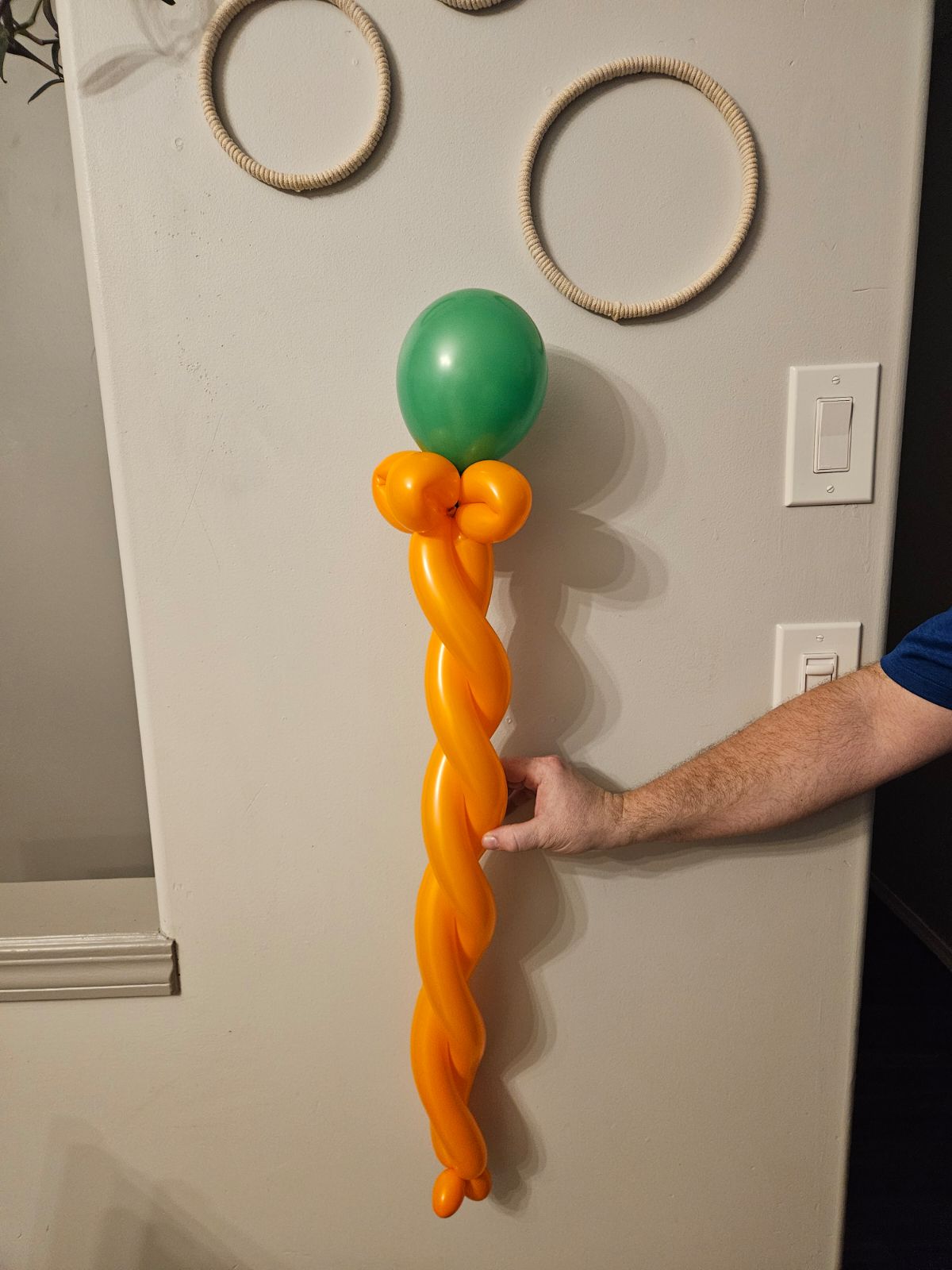 Orange and green balloon wand